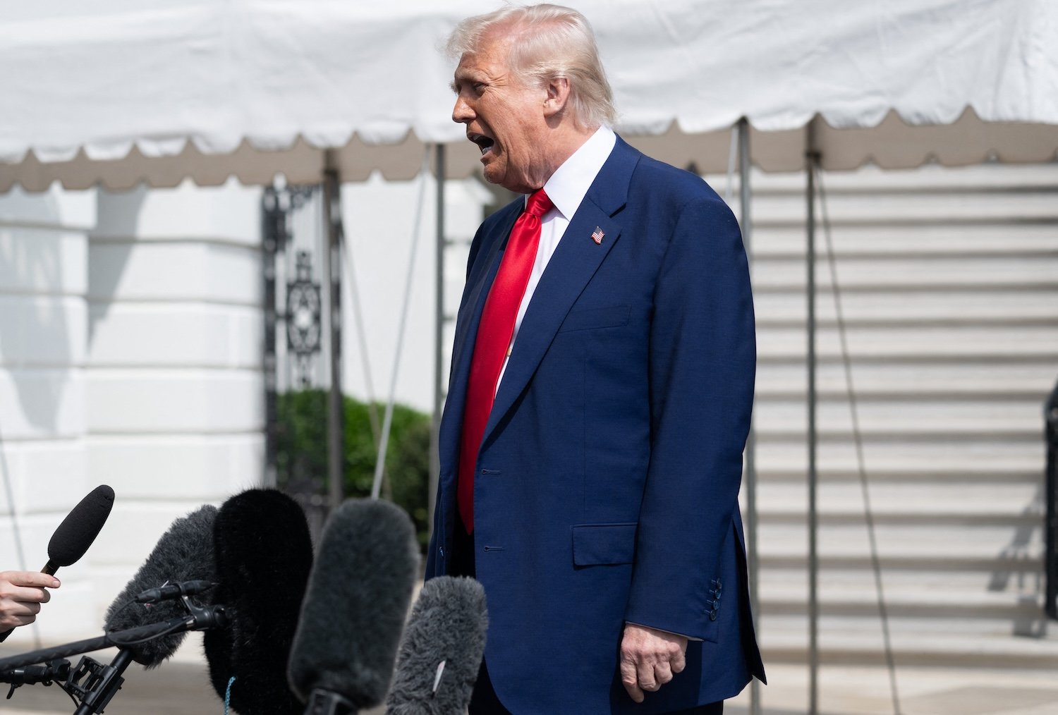 President Donald Trump speaks to reporters prior to departing from the South Lawn of the White House in Washington, DC, on April 3, 2025, as he travels to Florida for the weekend.
