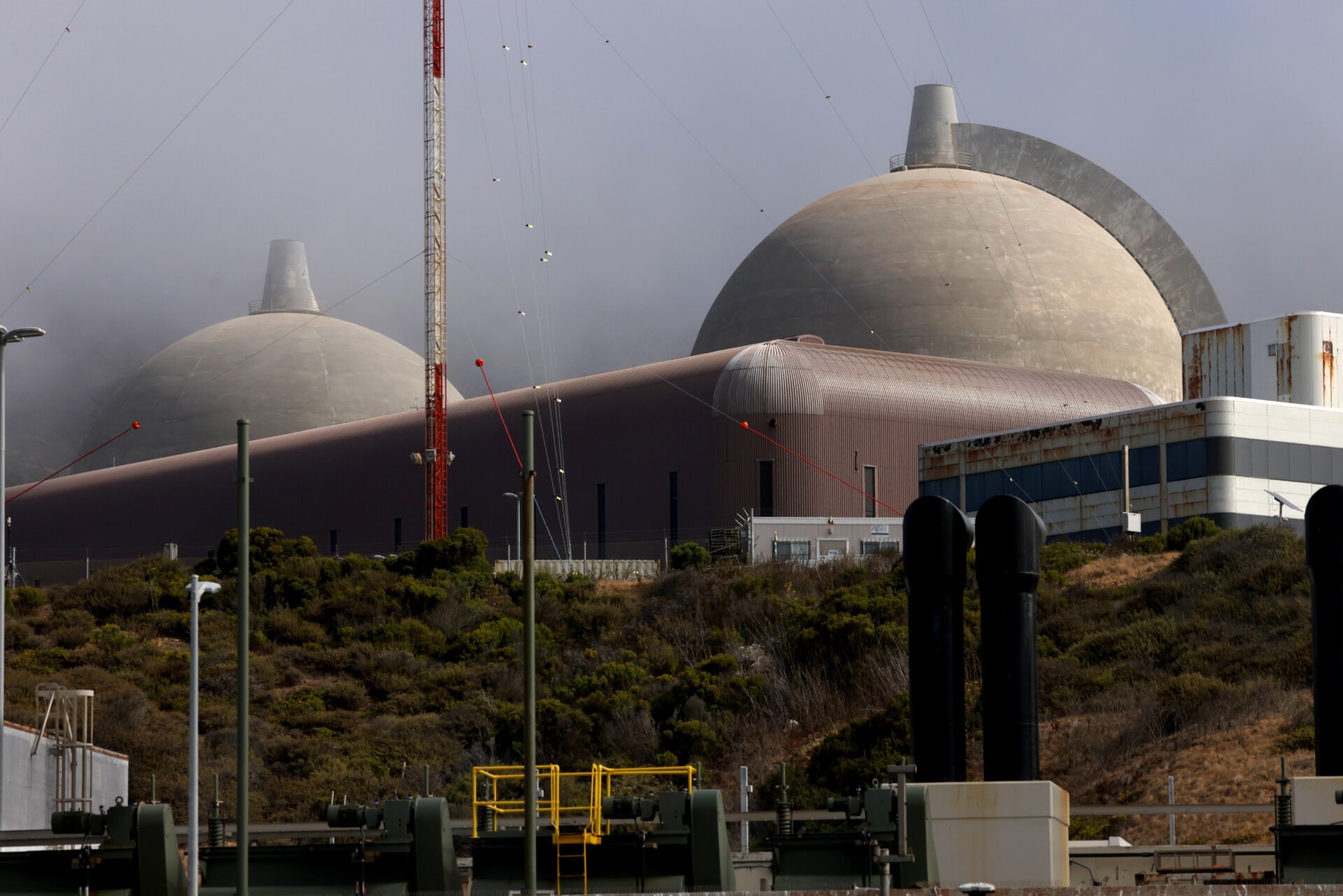 Twin containment domes, that house the nuclear reactors, clear the morning fog at the Diablo Nuclear Power Plant in San Luis Obispo on August 9, 2024.