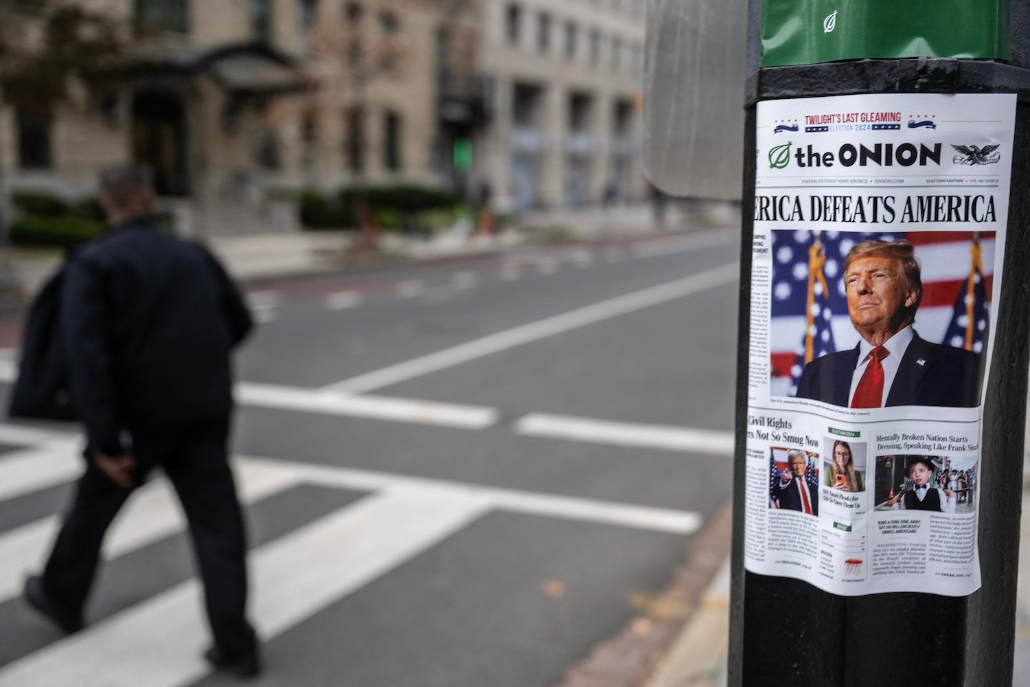 A copy of "The Onion" newspaper stapled onto a light pole.