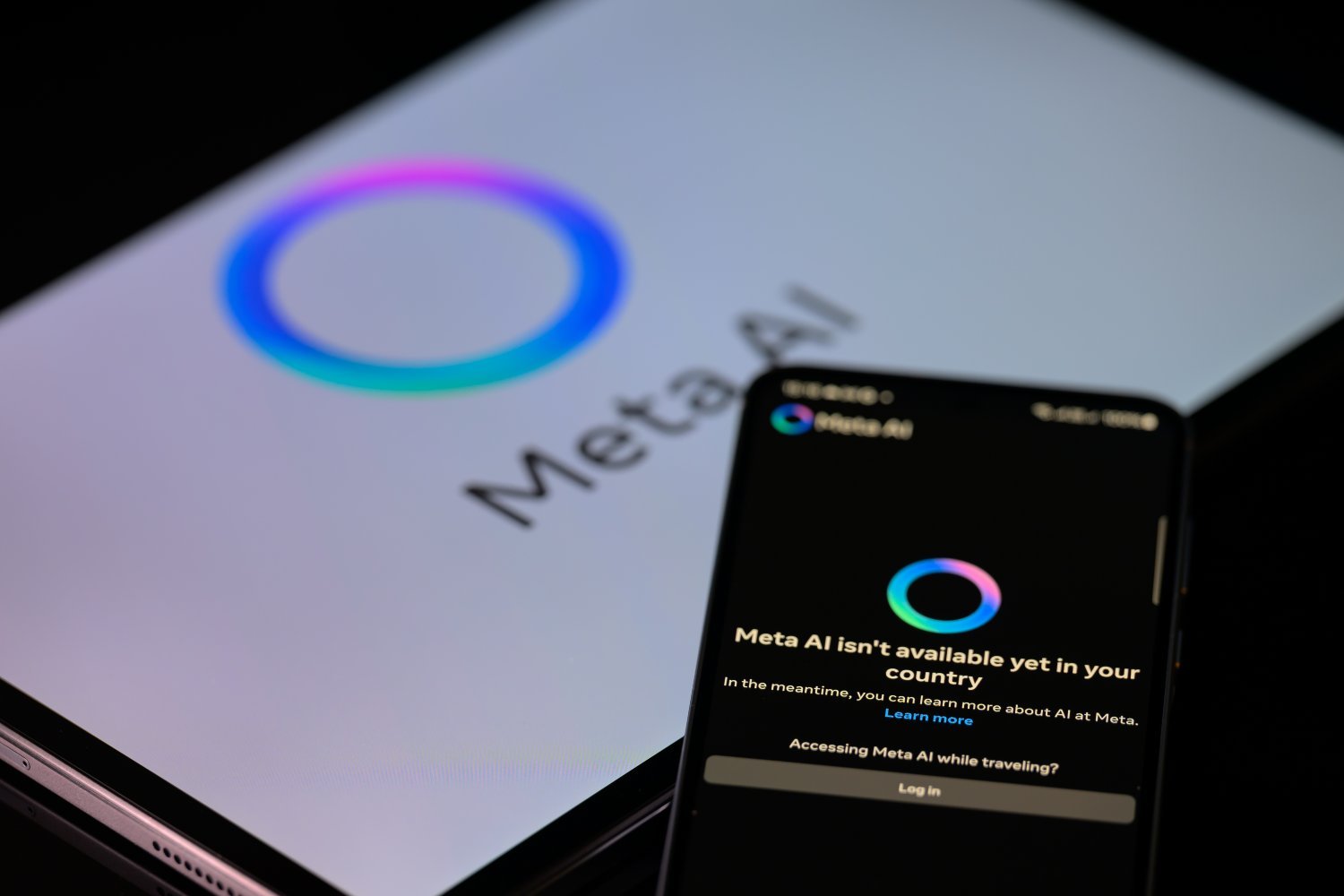 The Meta AI app is displayed on a mobile phone with the Meta AI logo visible on a tablet