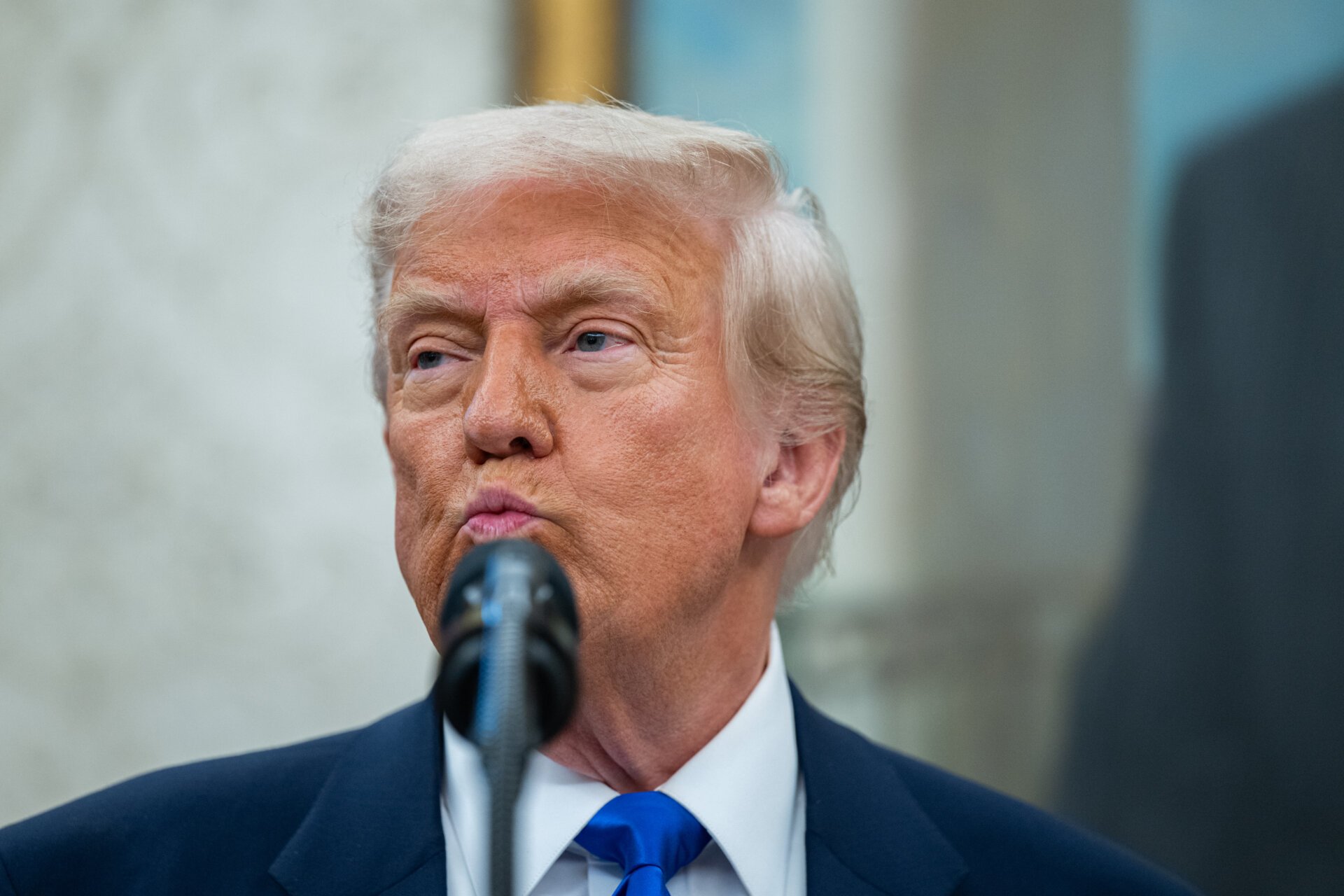 Trump appears in the Oval Office. State attorney's general are suing him over his wind farm policy.