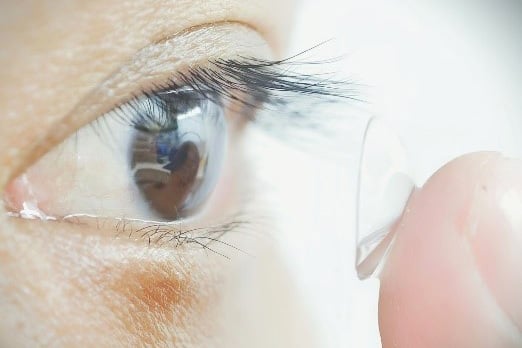 A person trying on infrared contact Lenses