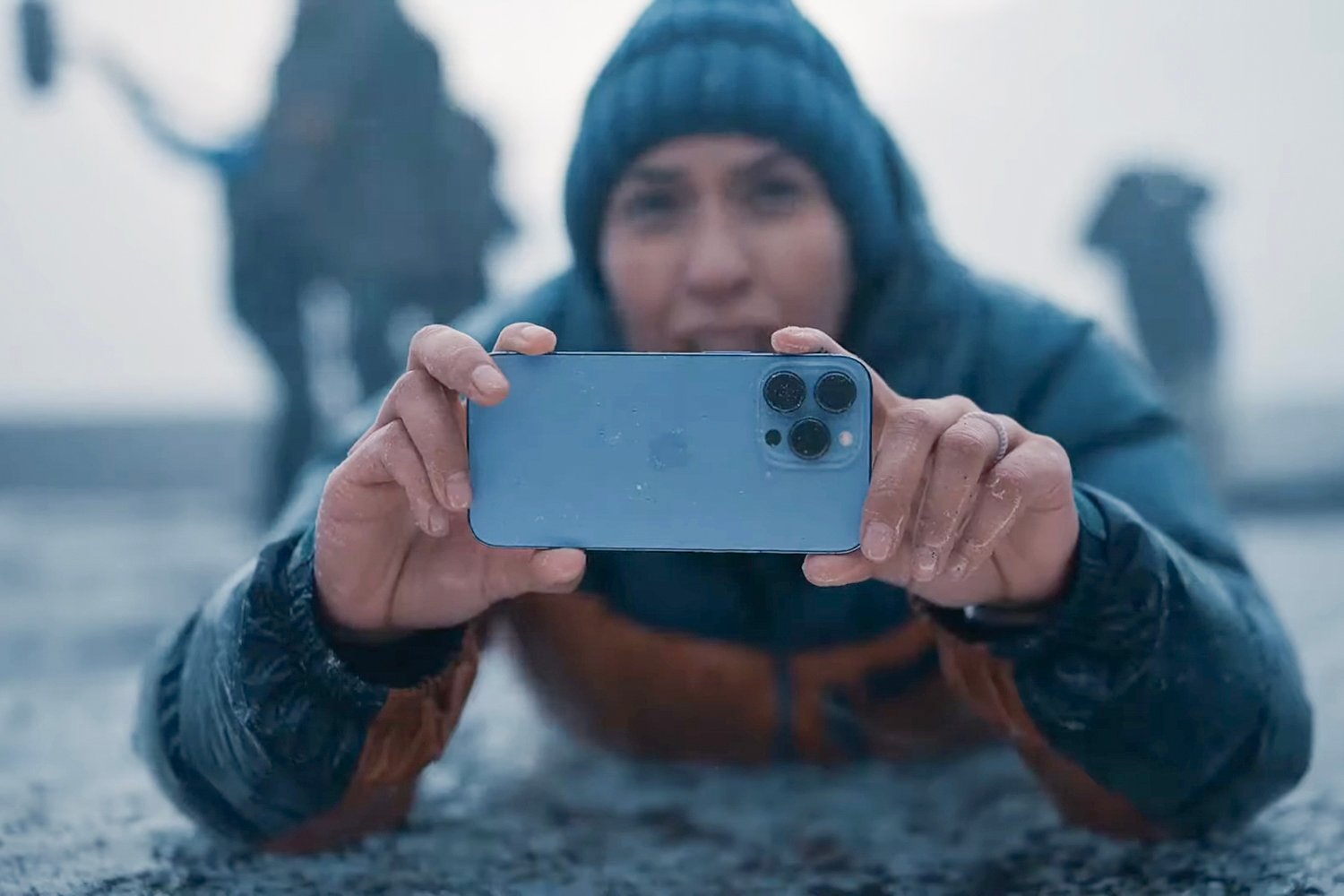 A person using an Apple iPhone 13 Pro in Sierra Blue to capture 4K video