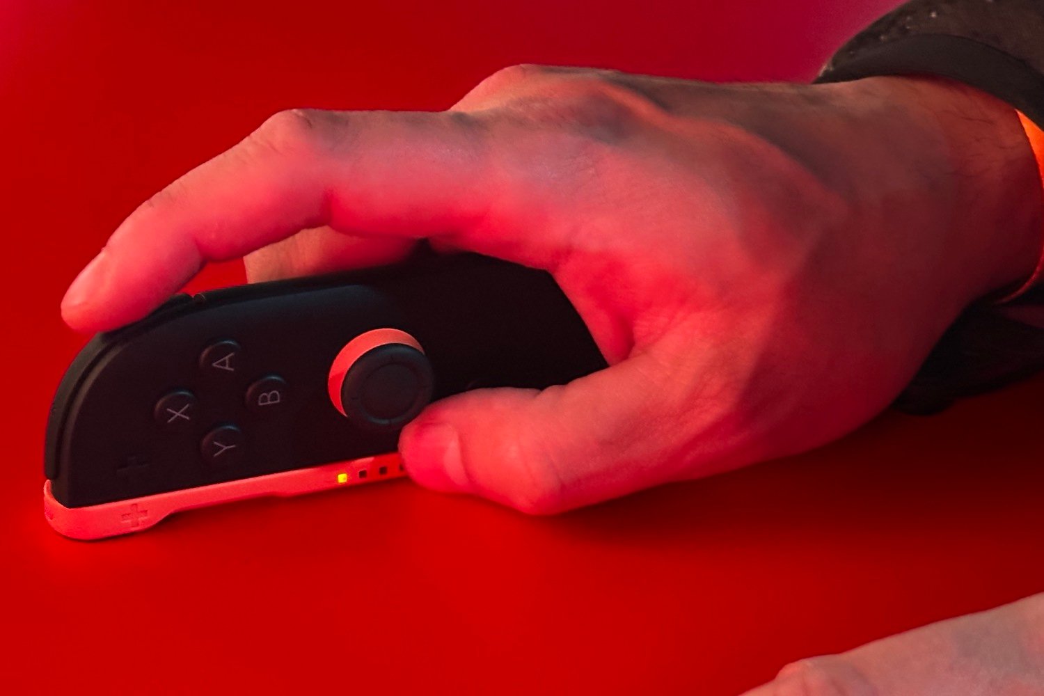And image of a man's hand holding the right Joy Con as a mouse.