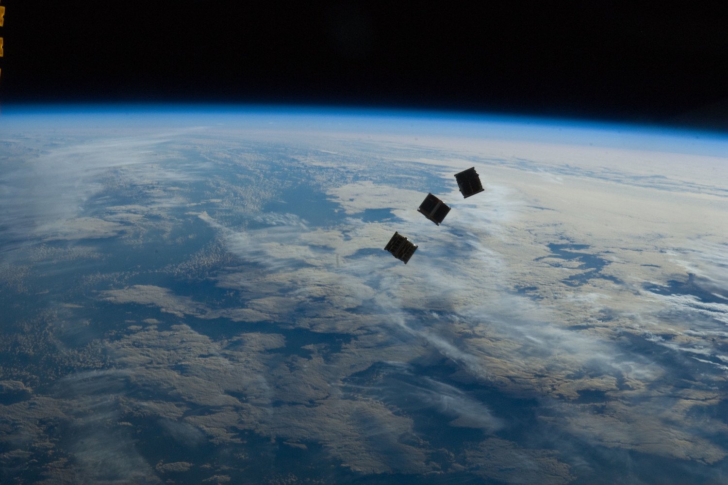 Several tiny satellites are featured in this image photographed by an Expedition 33 crew member on the International Space Station.