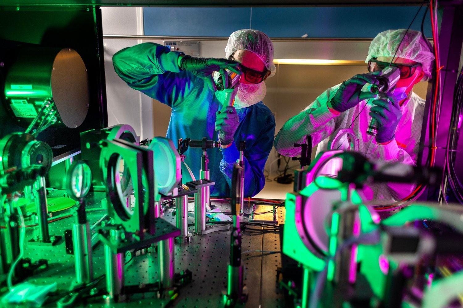 Engineers check optical alignments where the laser pulses are amplified.